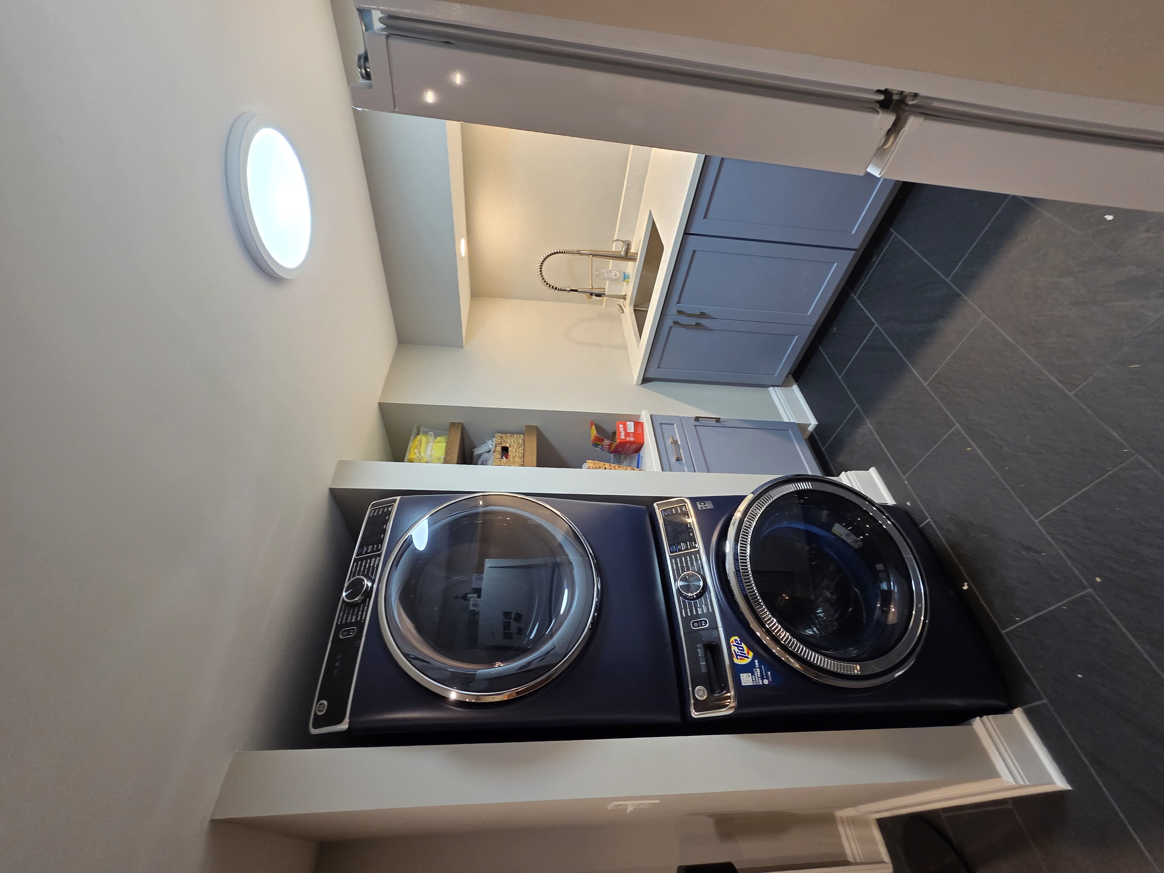 Custom laundry room with blue cabinetry