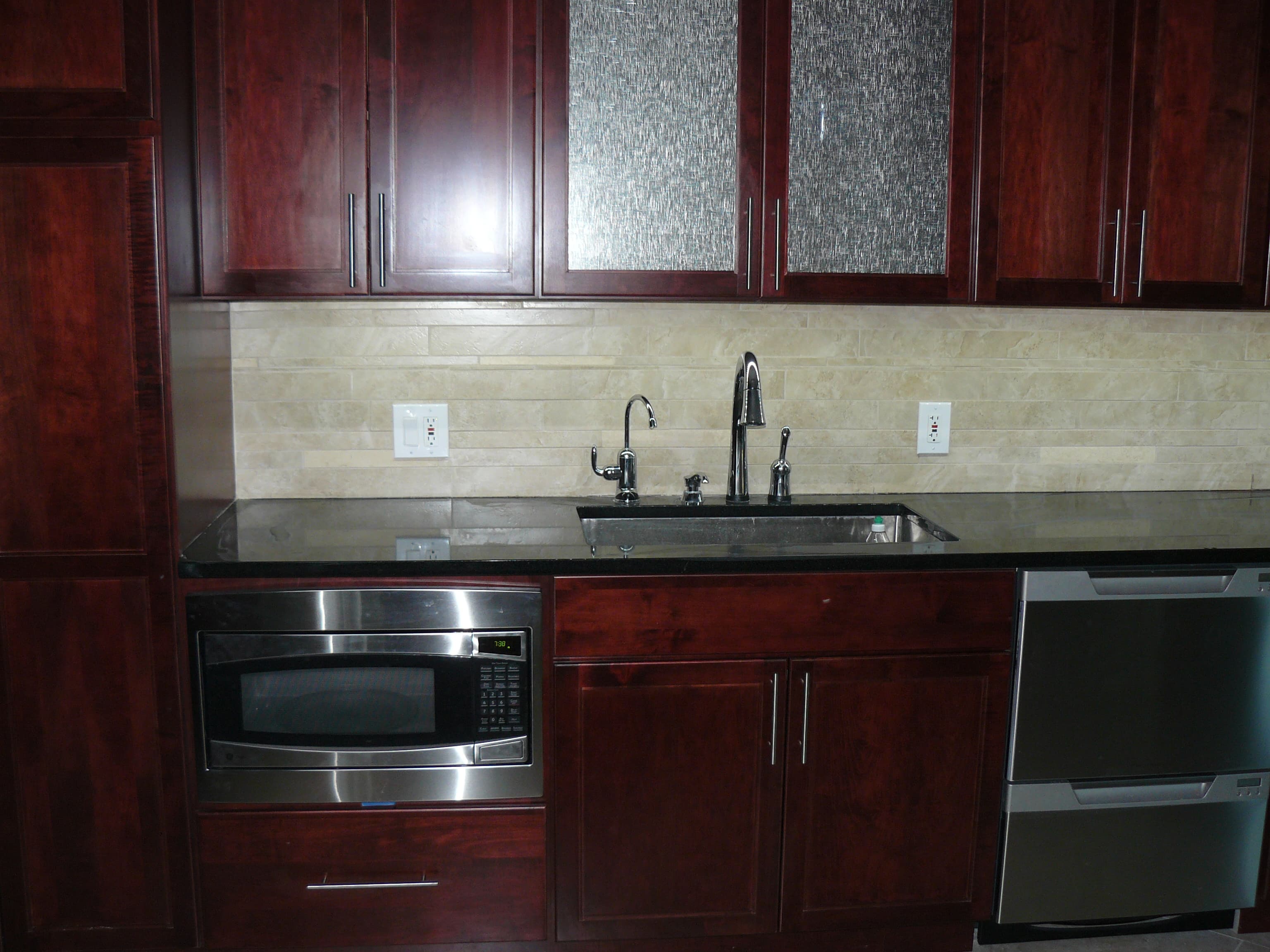 Kitchen with travertine backsplash and granite counters