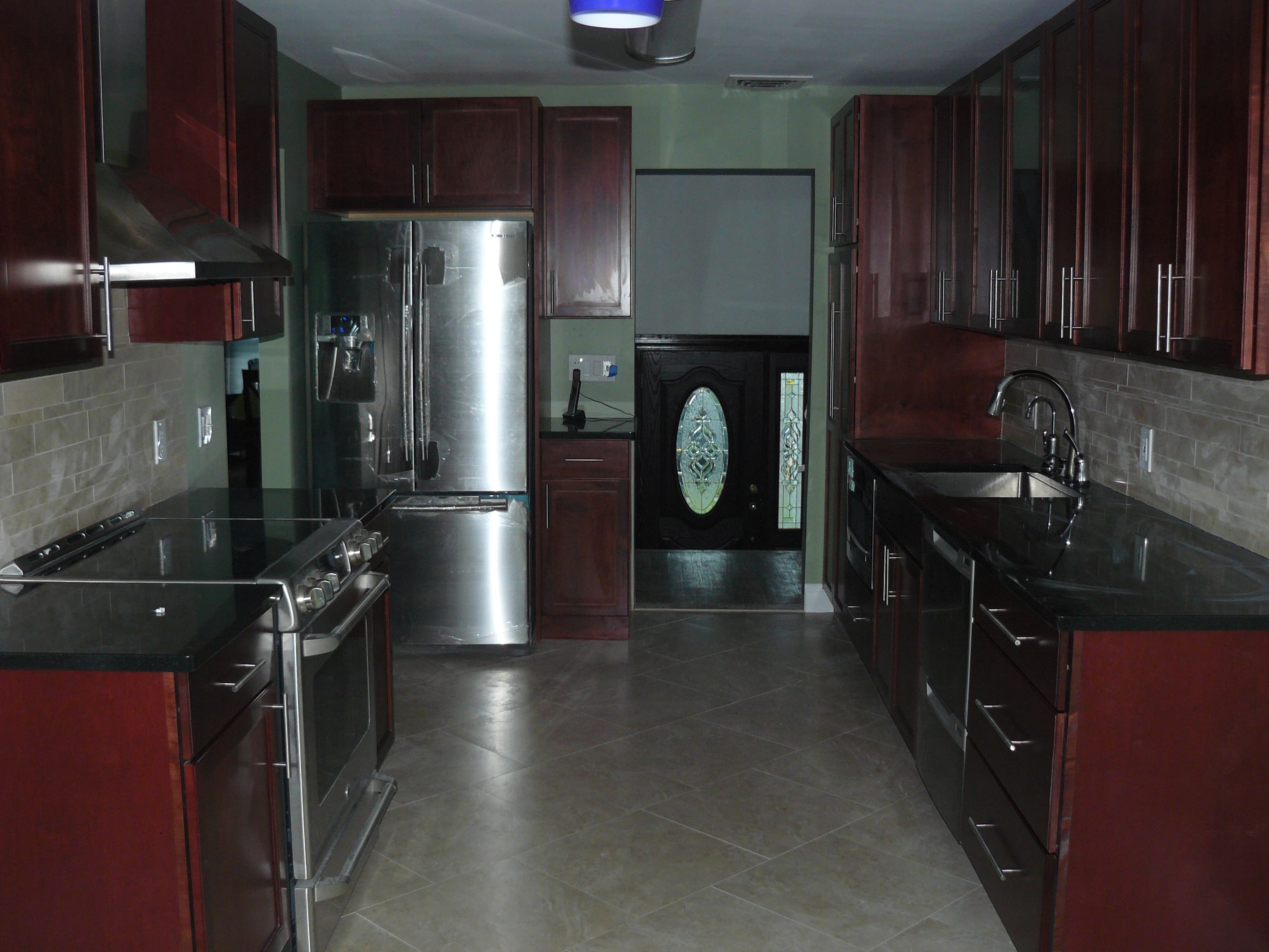 Modern kitchen with dark wood cabinets and granite
