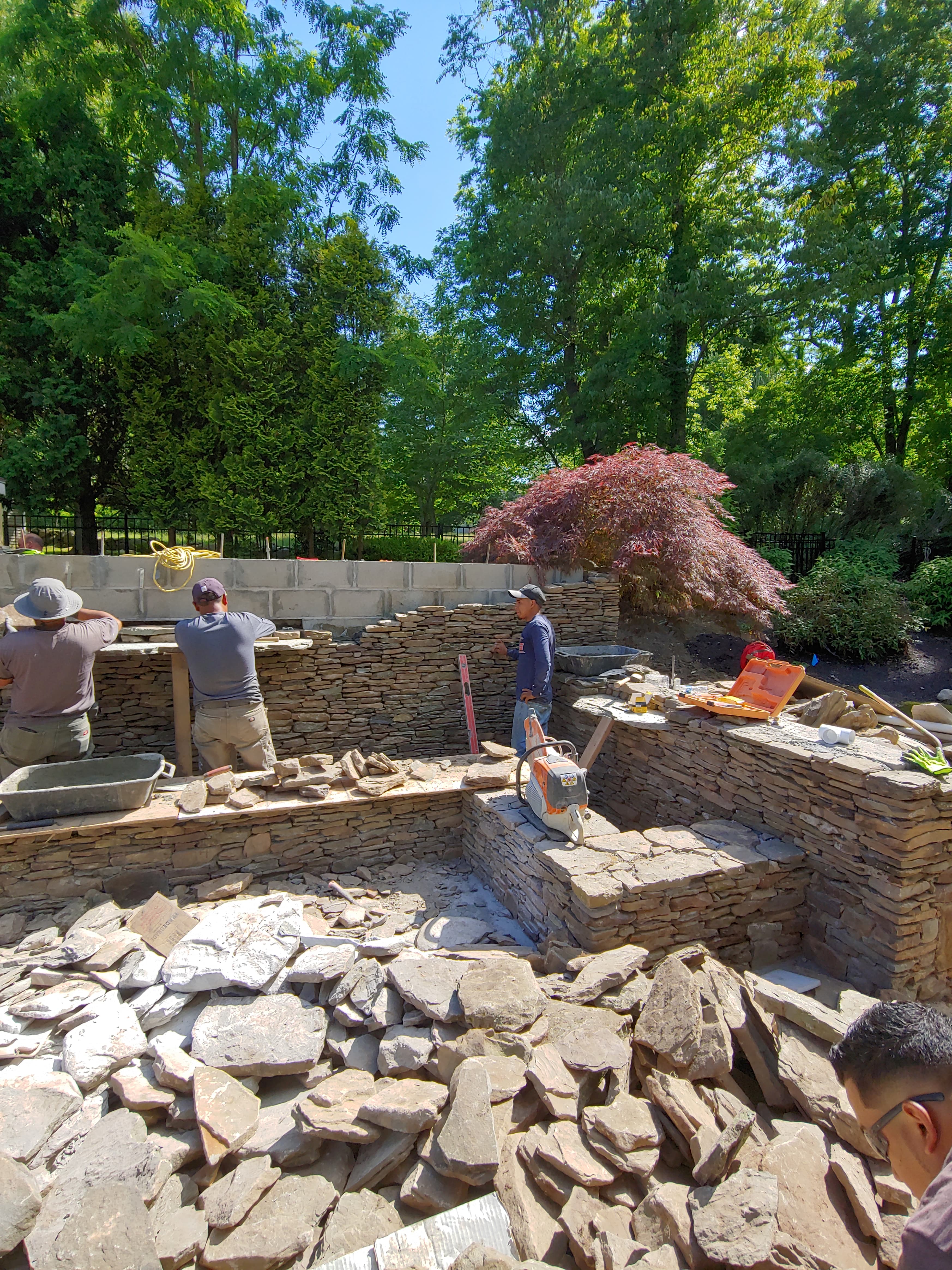 Koi pond with stone bridge and lush plantings